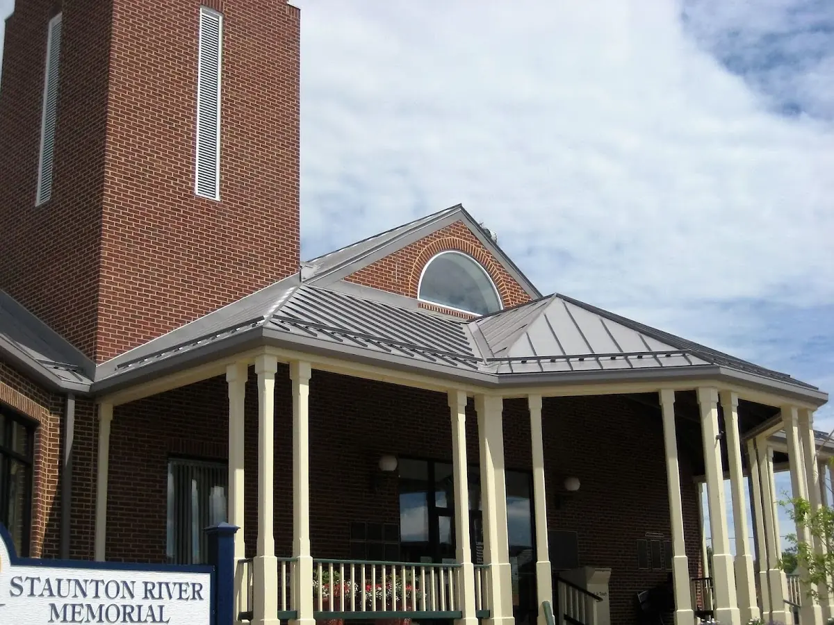 Skilled roofing craftsmen working on a residential roof in Clinton